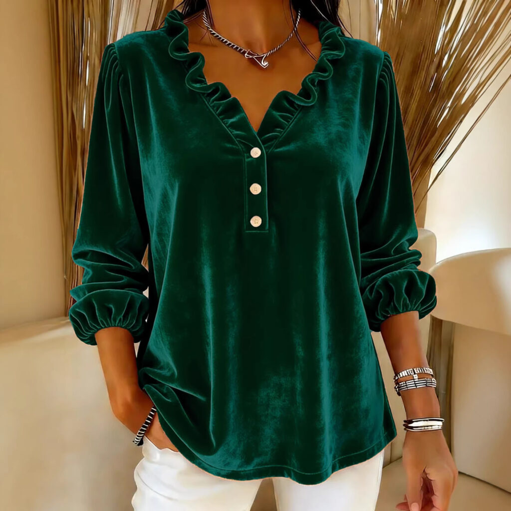 Woman in green ruffled blouse, white pants.