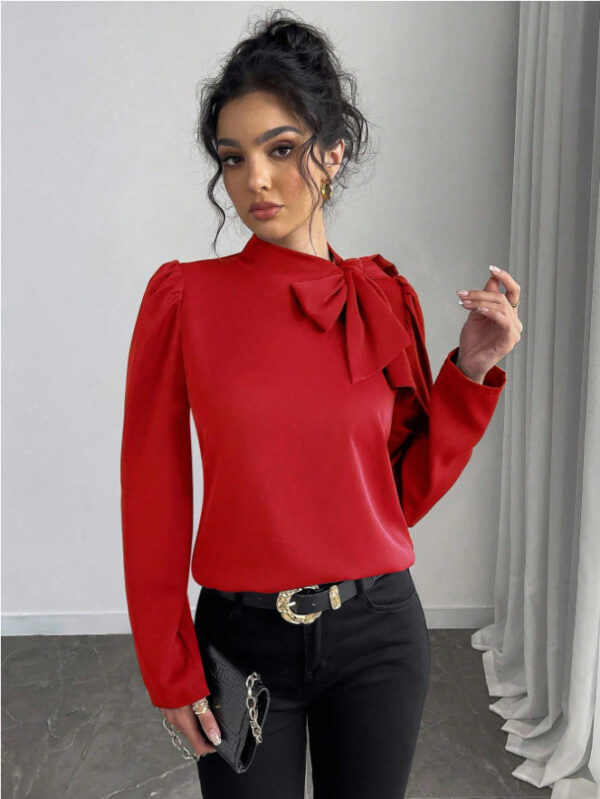 Woman in red blouse with bow.