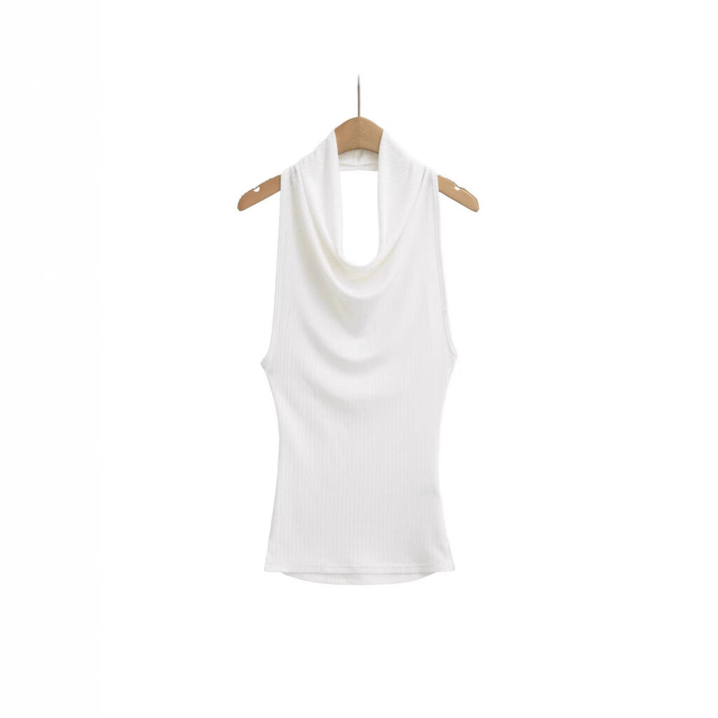 White sleeveless top on wooden hanger.