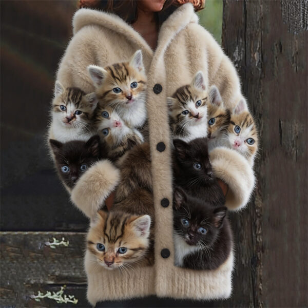Person wearing coat filled with kittens.