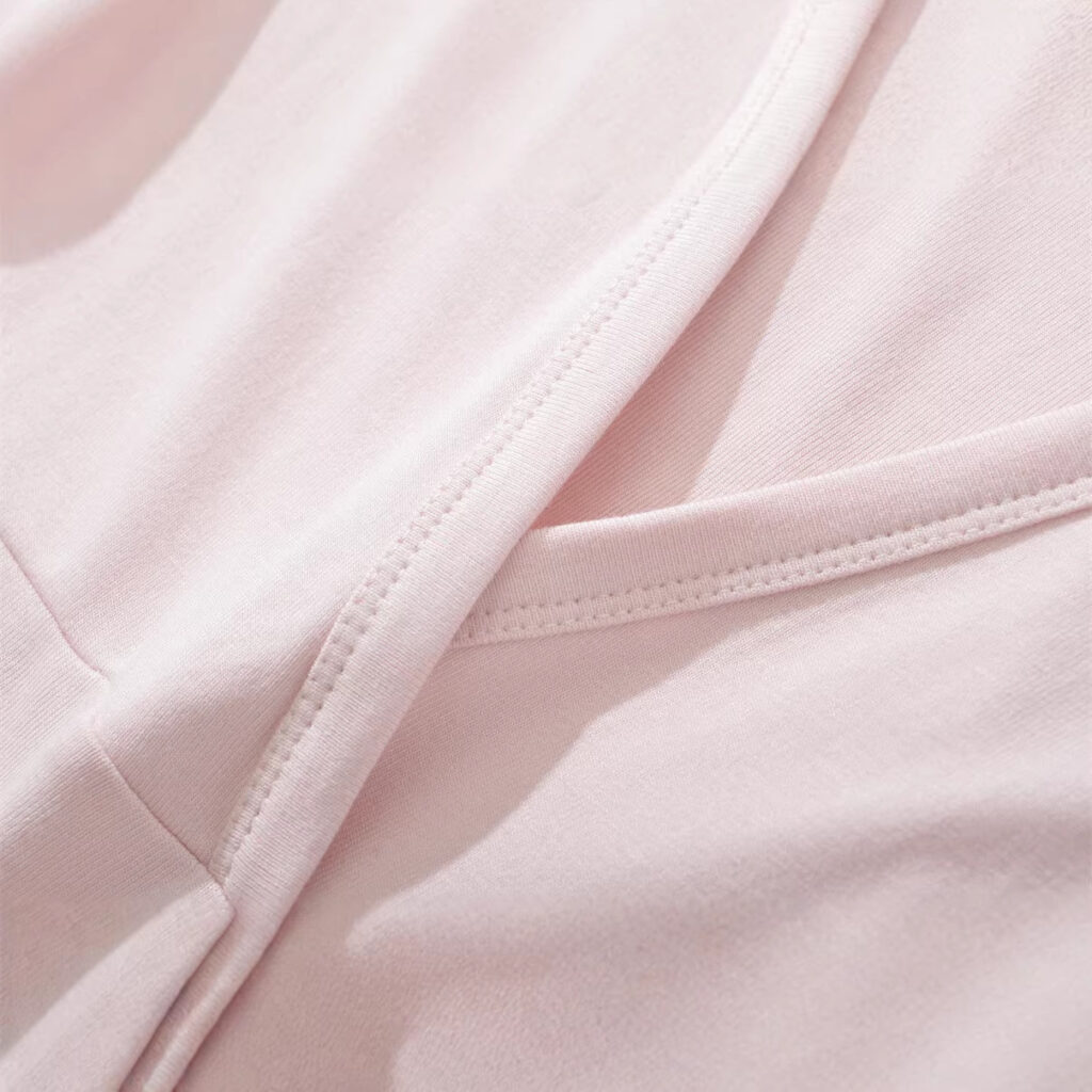 Close-up of pink fabric with seam.