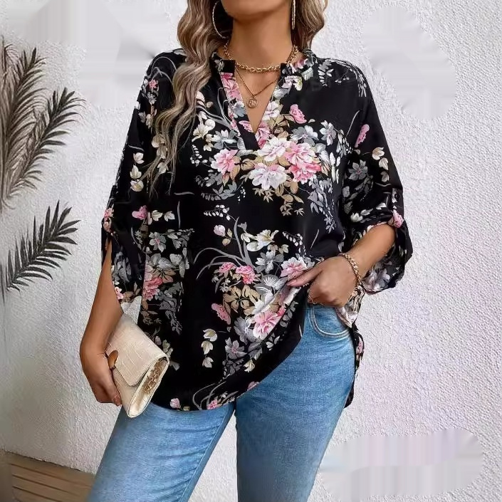 Woman in floral blouse and jeans.