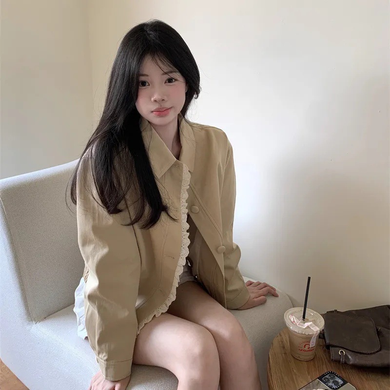 Young woman seated with a drink nearby.