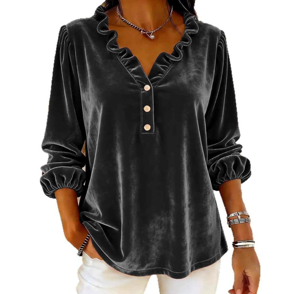 Woman wearing black velvet blouse with ruffles.