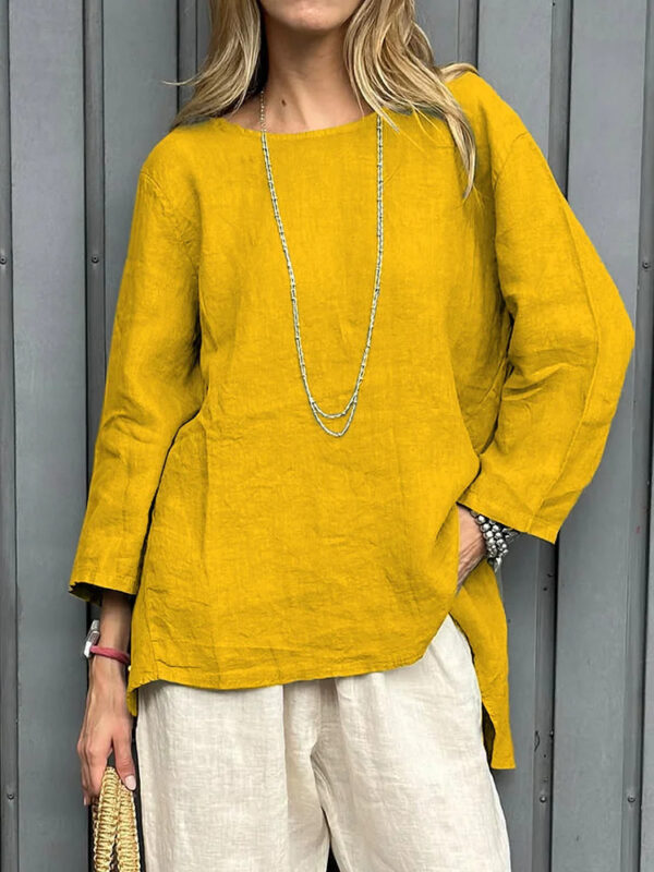 Woman in yellow top and beige pants.