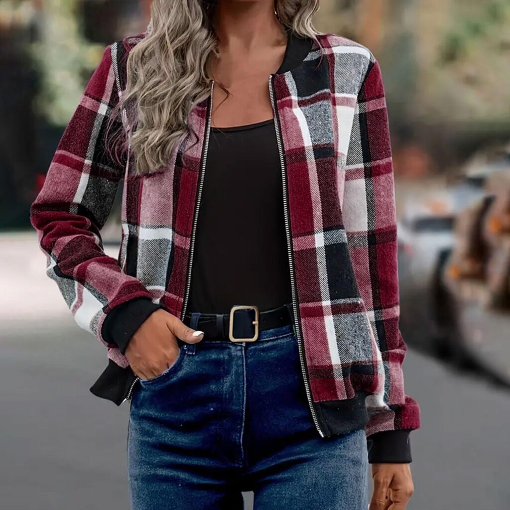 Woman wearing plaid jacket and jeans.