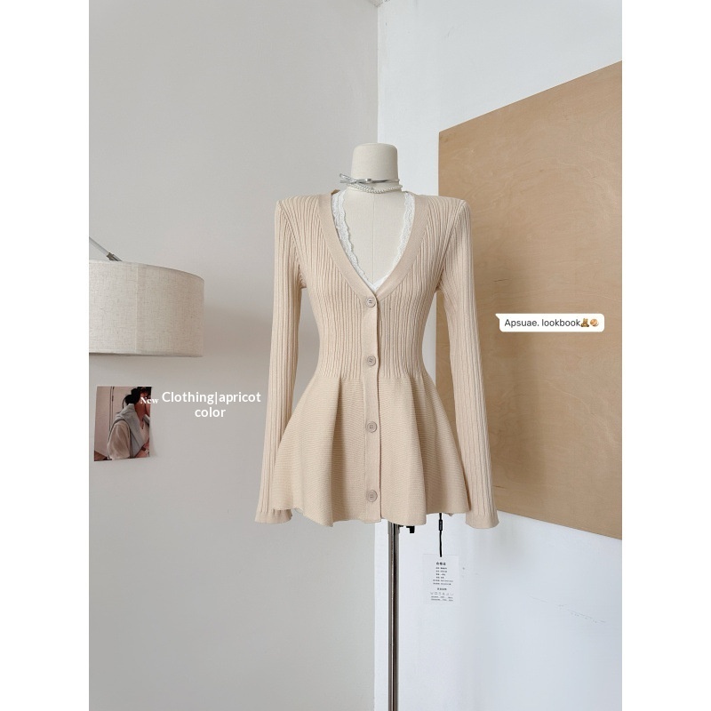 Apricot-colored ribbed cardigan on mannequin display.