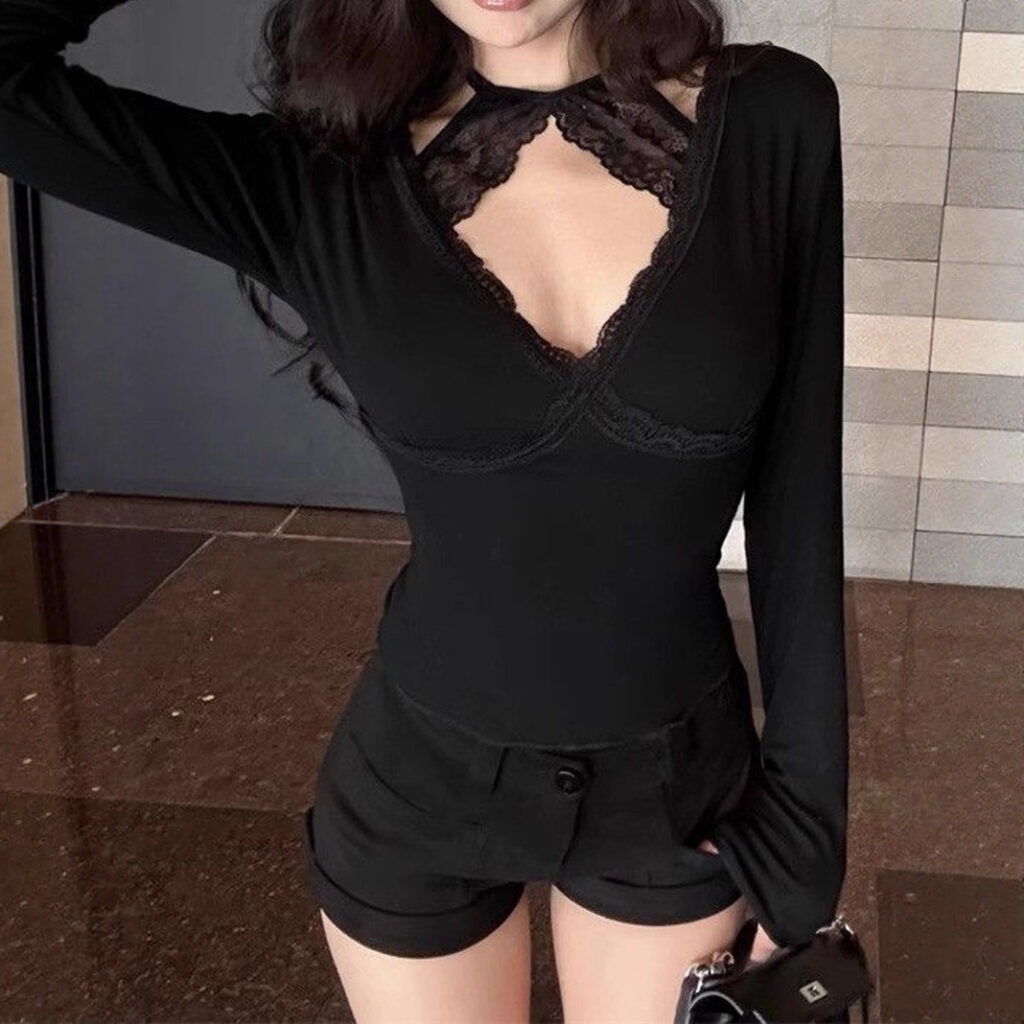 Woman in black lace top and shorts.
