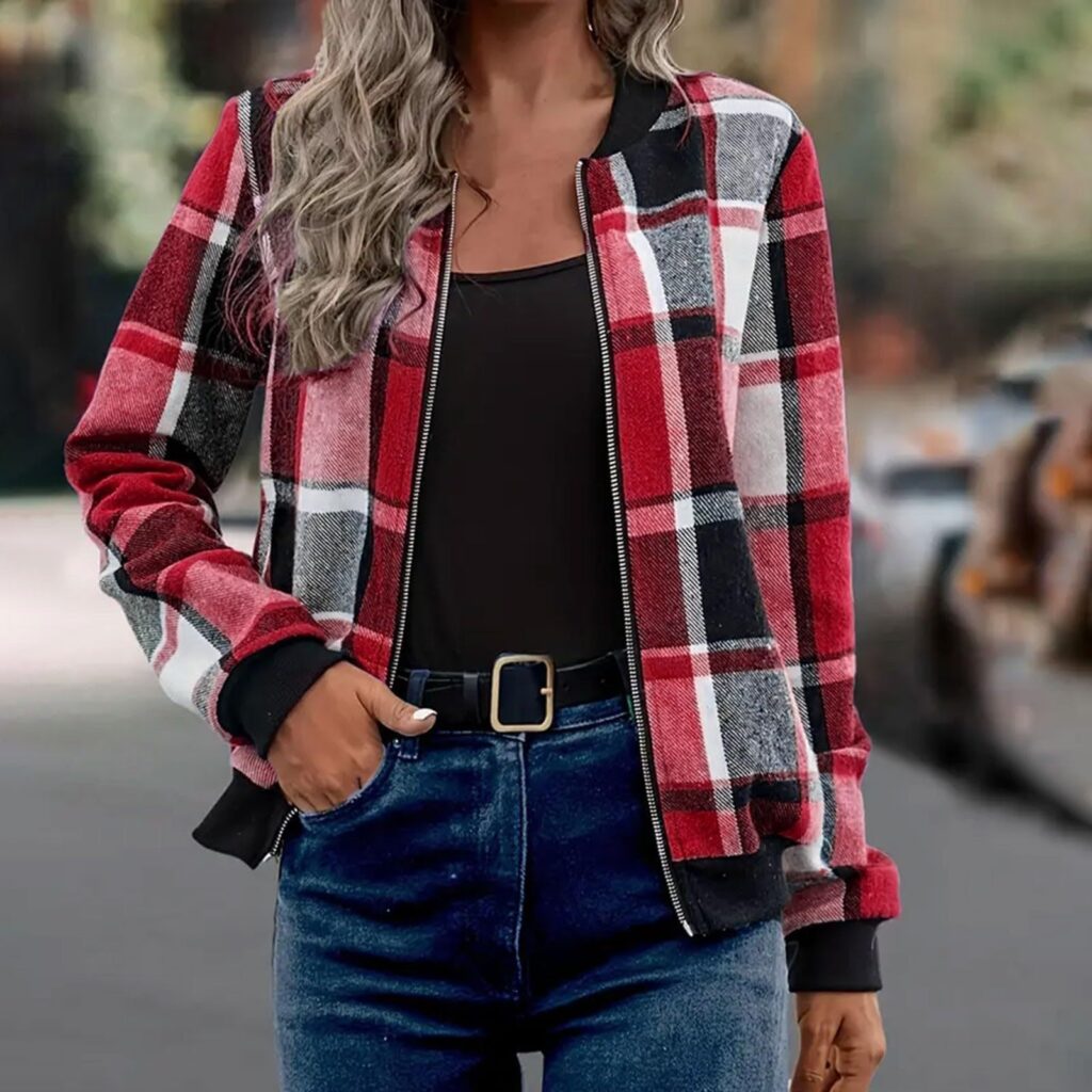 Woman in plaid jacket and jeans outdoors.