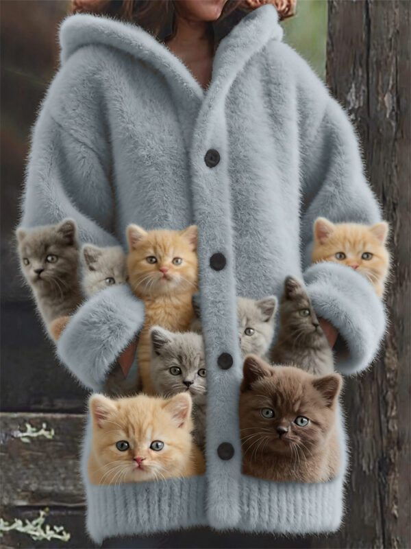 Person wearing coat with kittens in pockets.