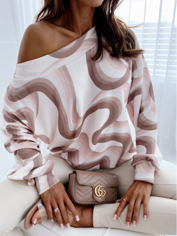 Woman in patterned sweater with handbag.