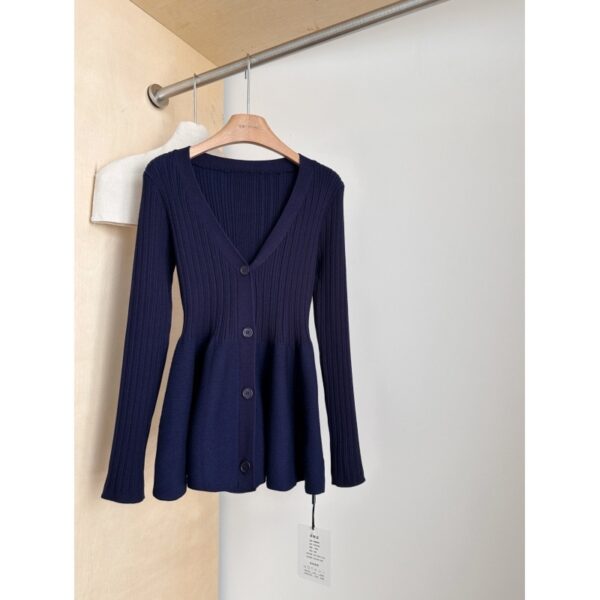 Navy ribbed cardigan on wooden hanger.