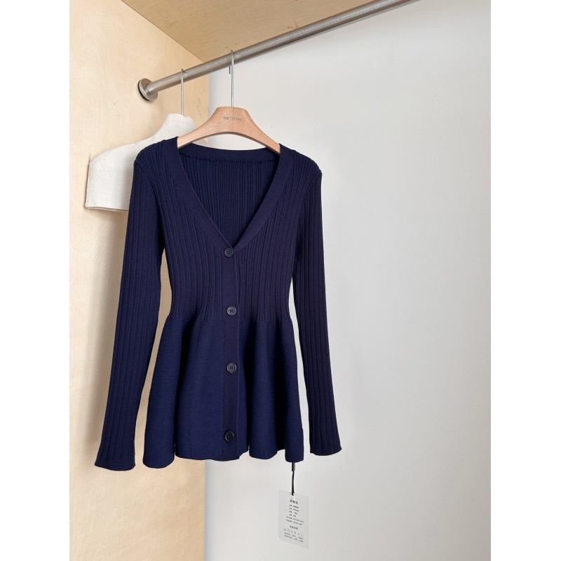 Navy ribbed cardigan on wooden hanger.