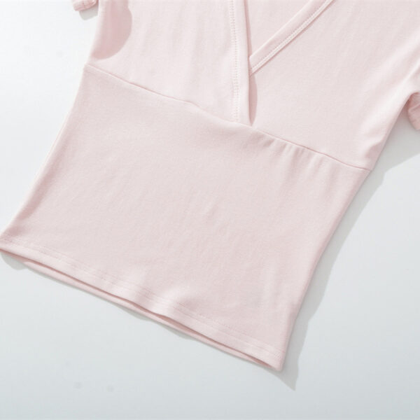 Light pink V-neck short sleeve shirt.