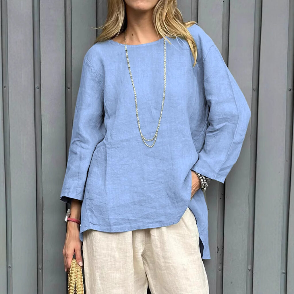 Woman in blue top and beige pants.