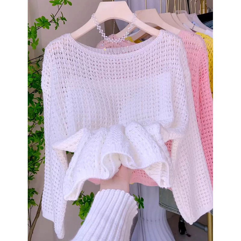 White knitted sweater on a hanger display.