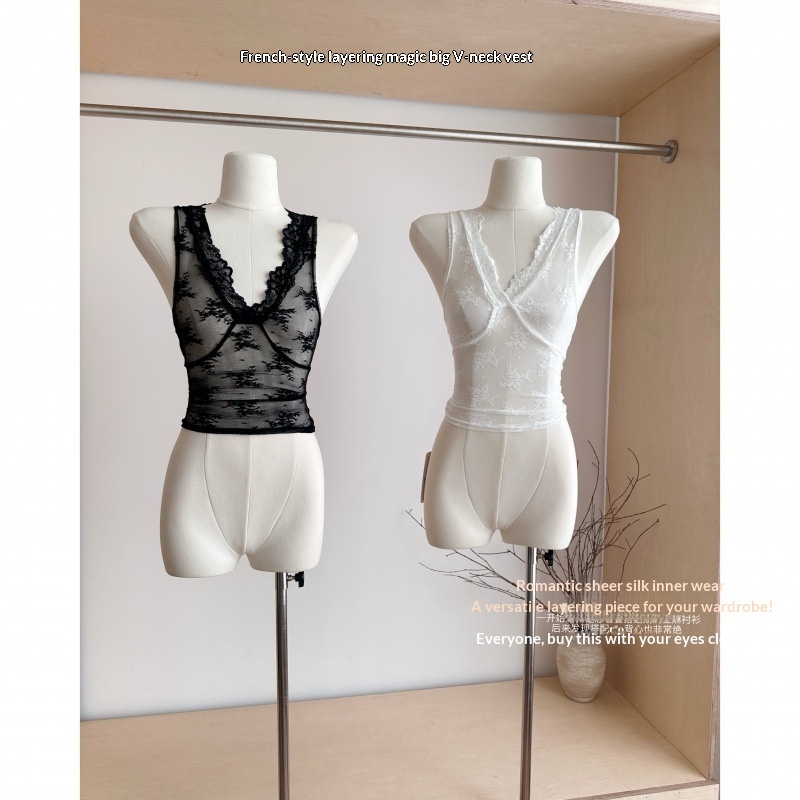 Two lace sleeveless tops on mannequins.
