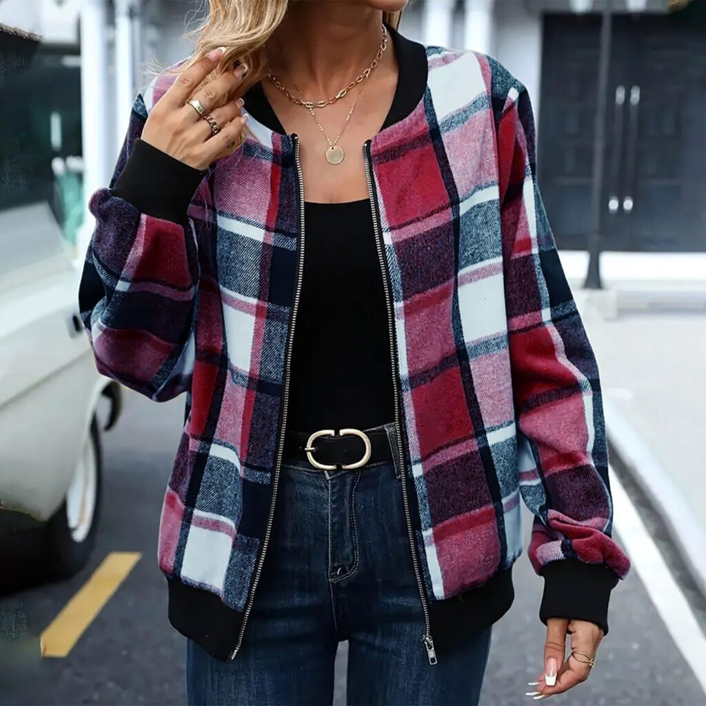 Woman wearing plaid jacket and jeans.