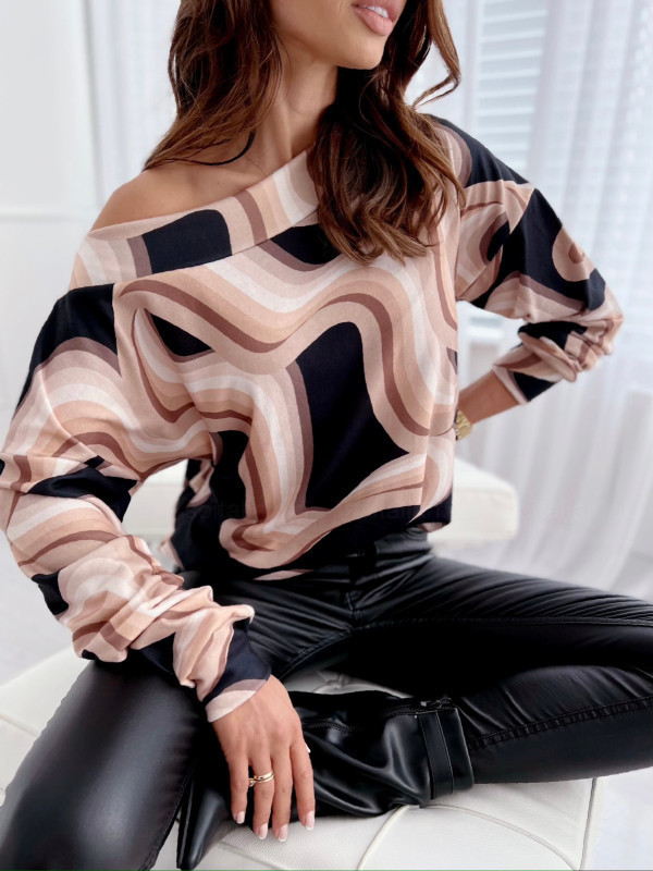 Woman in stylish patterned top and pants.
