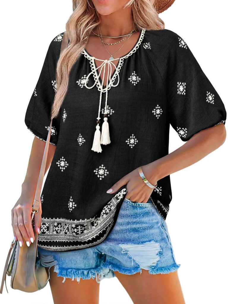 Woman in black boho top and shorts.