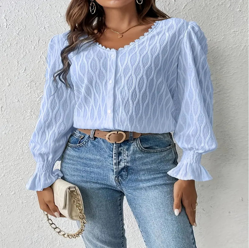 Woman in blue top and jeans.