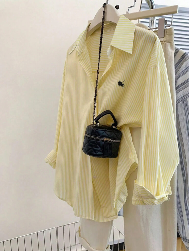 Yellow striped shirt with small black bag.