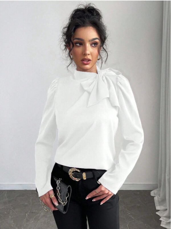 Woman in stylish white blouse and pants.