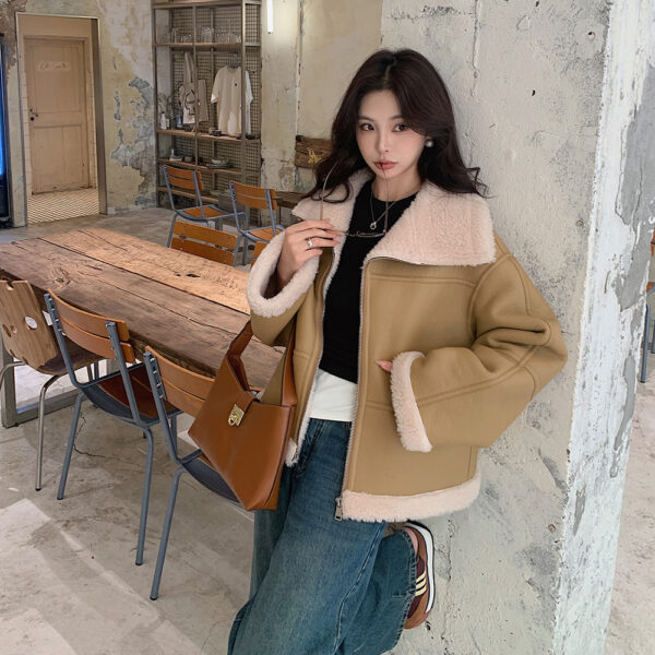 Woman in cozy jacket in rustic room.