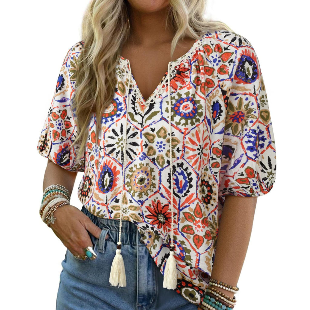 Woman wearing colorful patterned blouse and jeans.