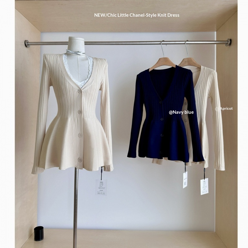 Three knit dresses on display stand.