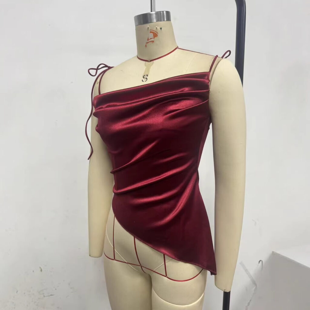 Red satin top on dress form mannequin.
