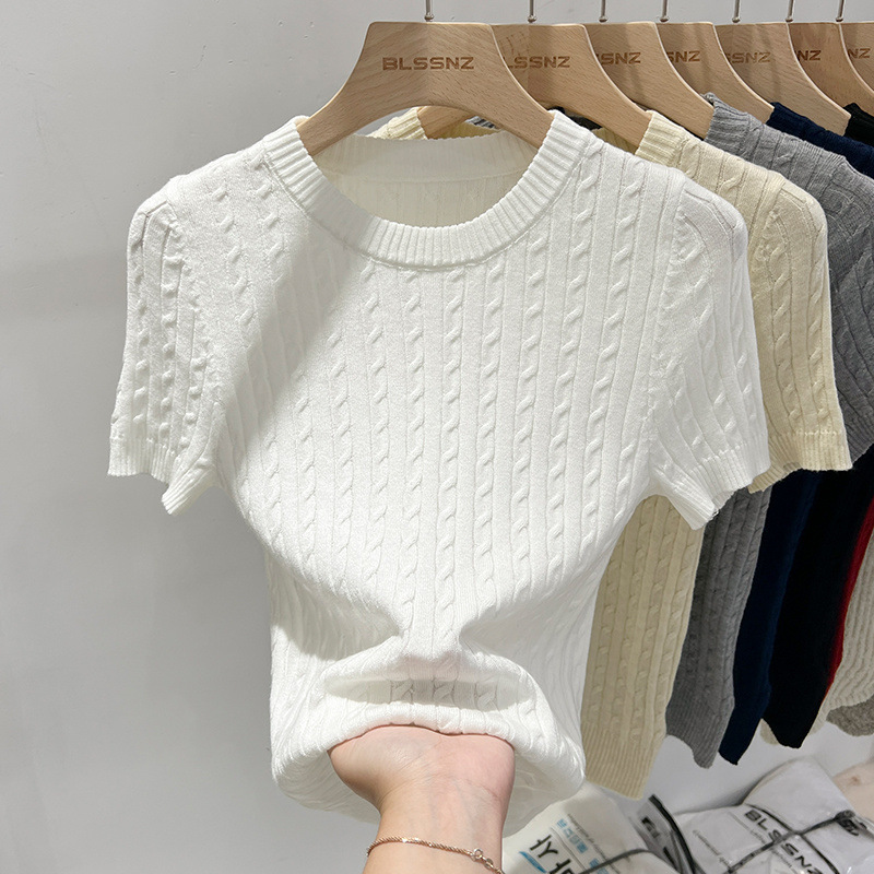 Hanging knit sweaters in various colors.