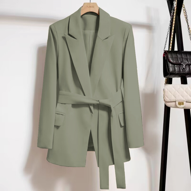 Green blazer with belt on hanger.