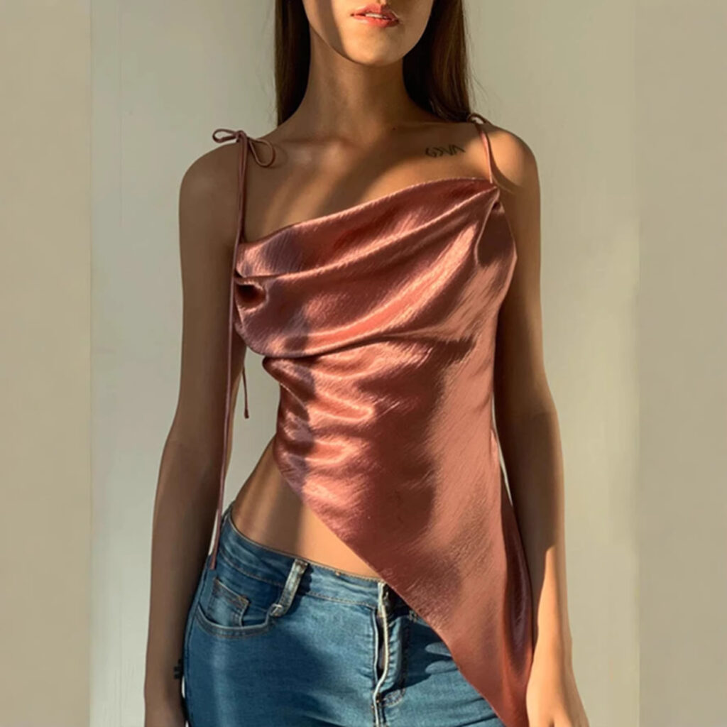 Woman wearing satin top and jeans.