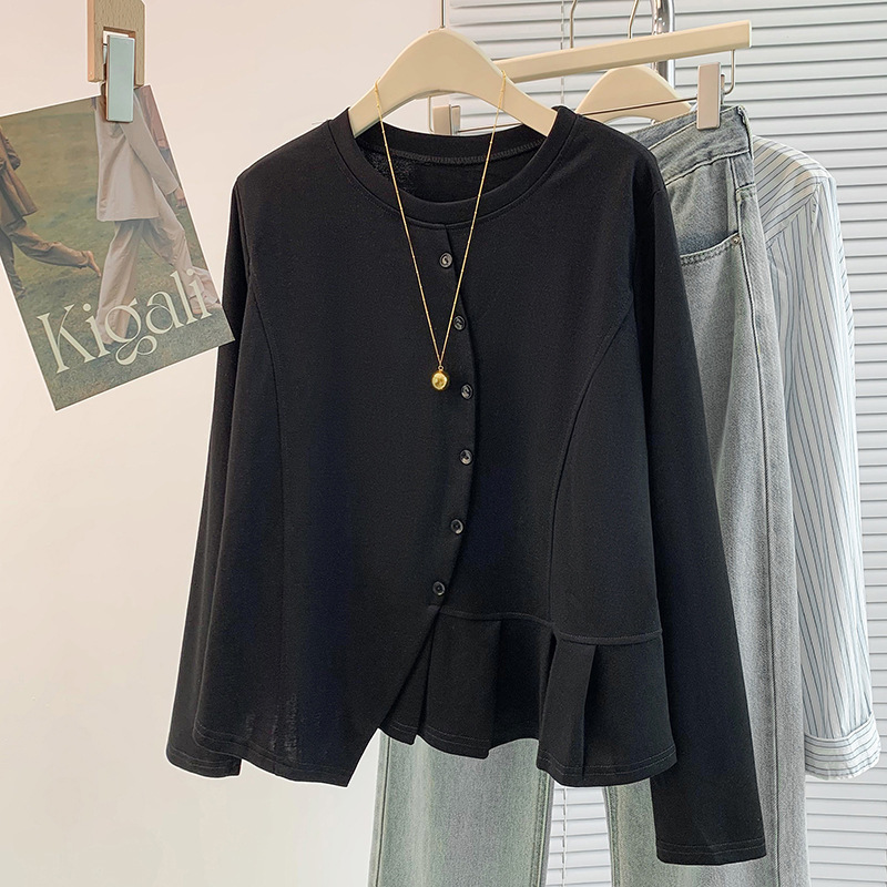 Black blouse with necklace on hanger.