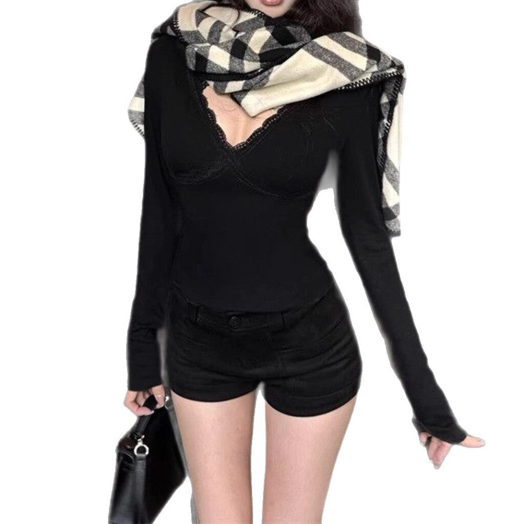 Woman in black outfit with checkered scarf.