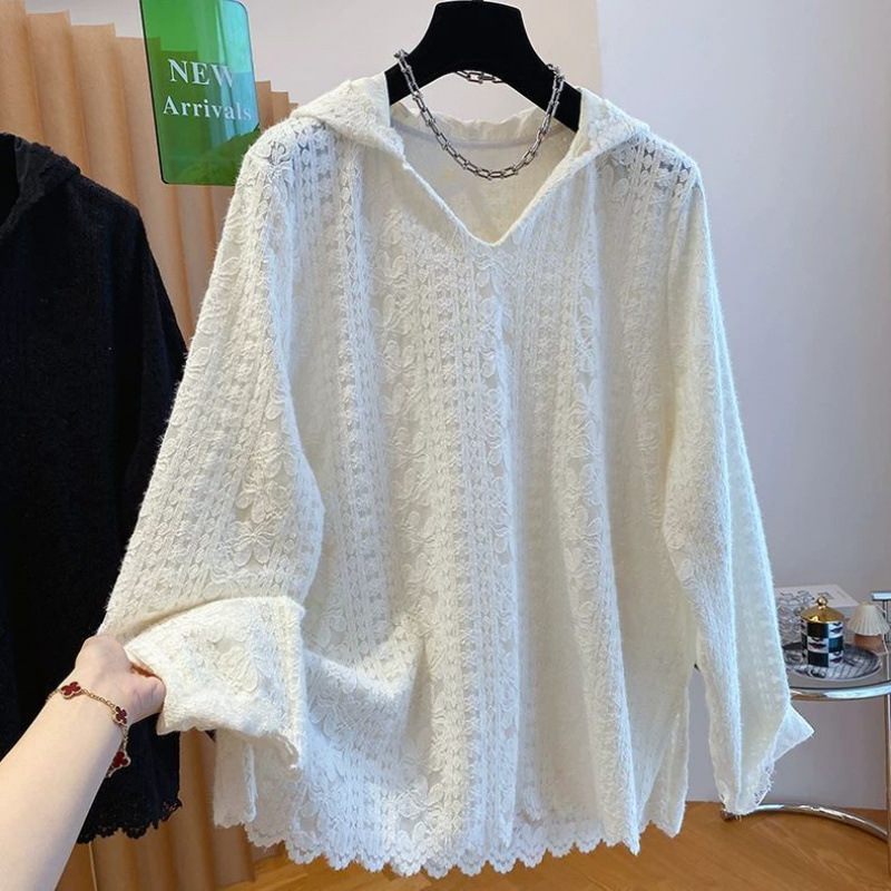 White knit sweater on a hanger display.