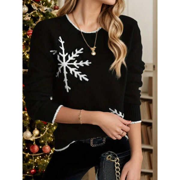 Woman wearing snowflake sweater by Christmas tree.