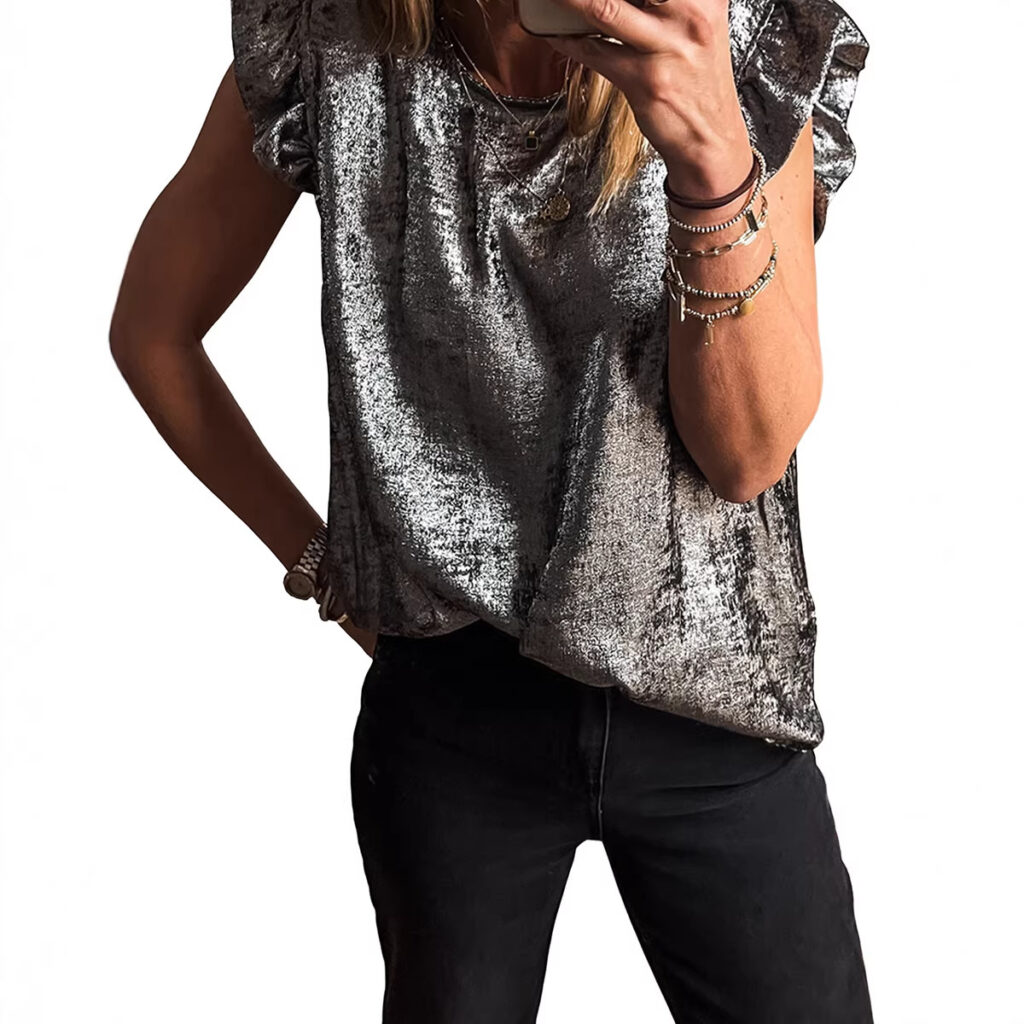 Person wearing silver top and black pants.
