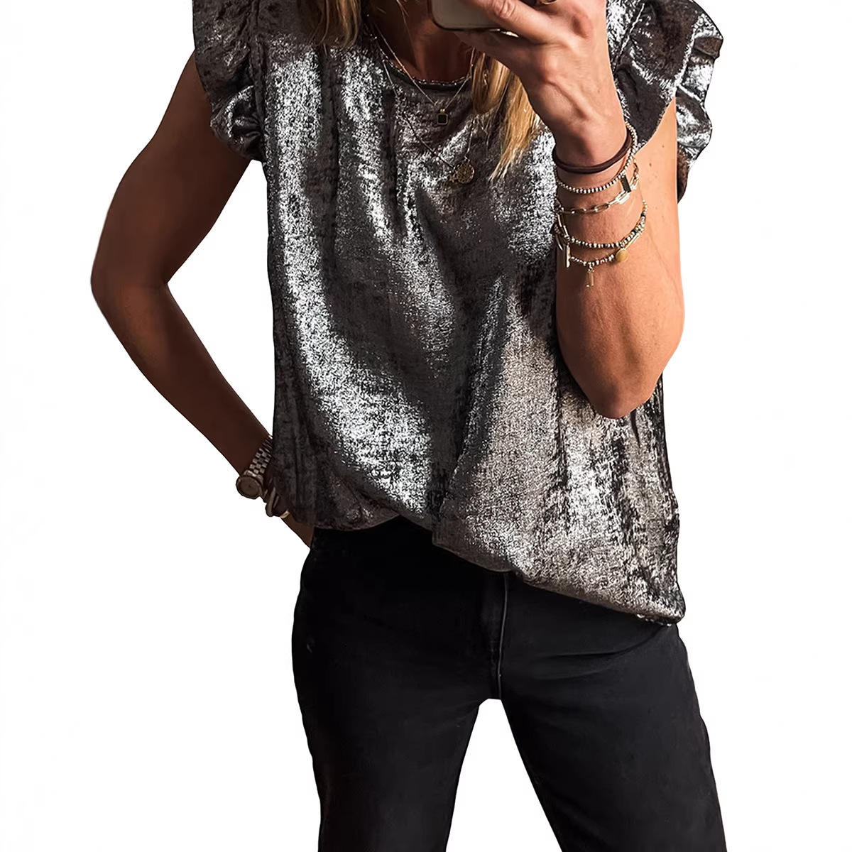 Person wearing silver top and black pants.