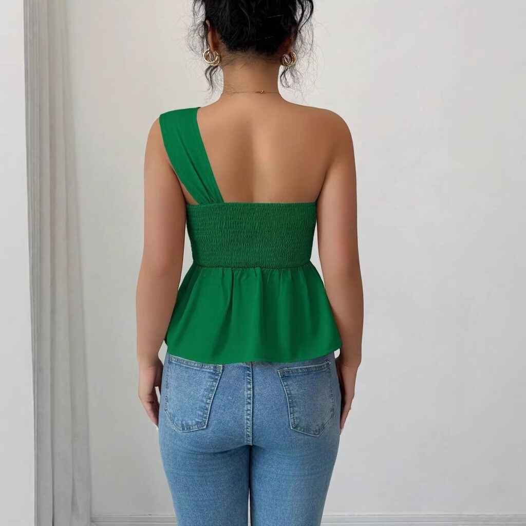 Woman in green top and jeans, back view.