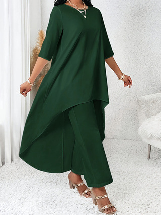 Woman in elegant green asymmetrical dress.