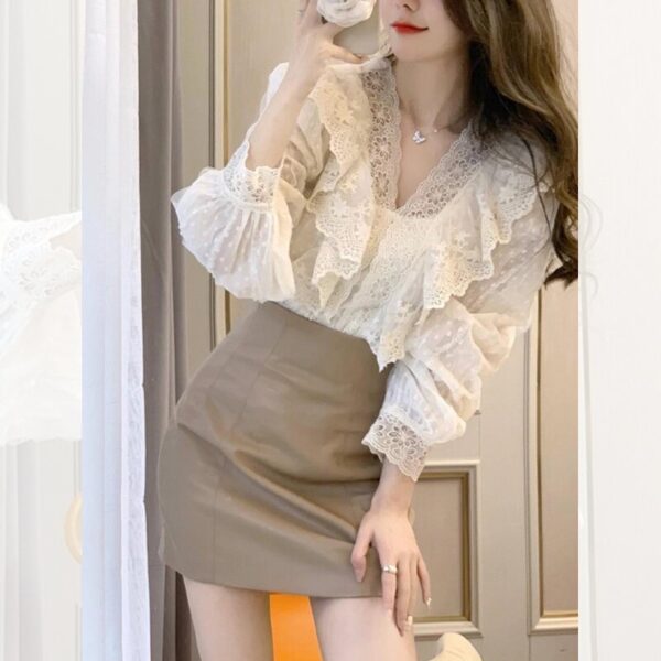 Woman in lace top and beige skirt.