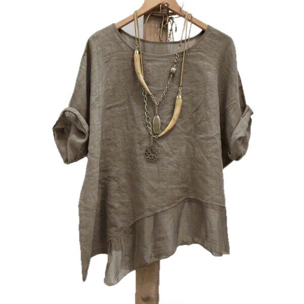 Gray shirt with long necklace on hanger.