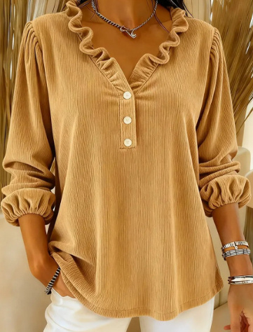 Brown ruffled blouse with white buttons.