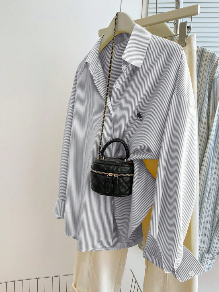 Striped shirt with small black handbag hanging.