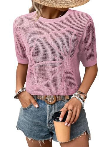 Woman in pink sweater holding coffee cup.