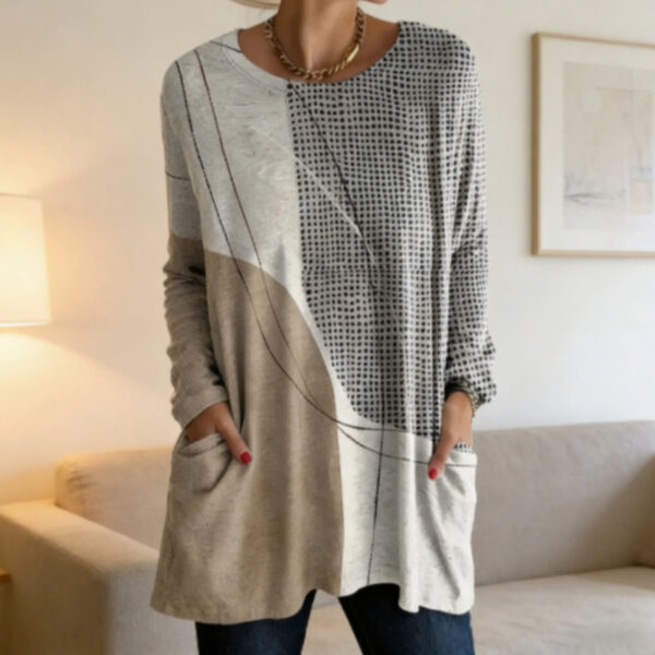 Person wearing patterned long-sleeve shirt indoors.