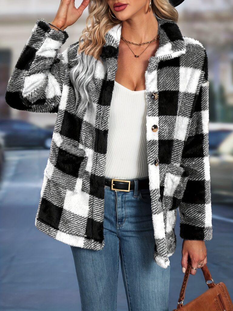 Woman in plaid coat holding handbag.