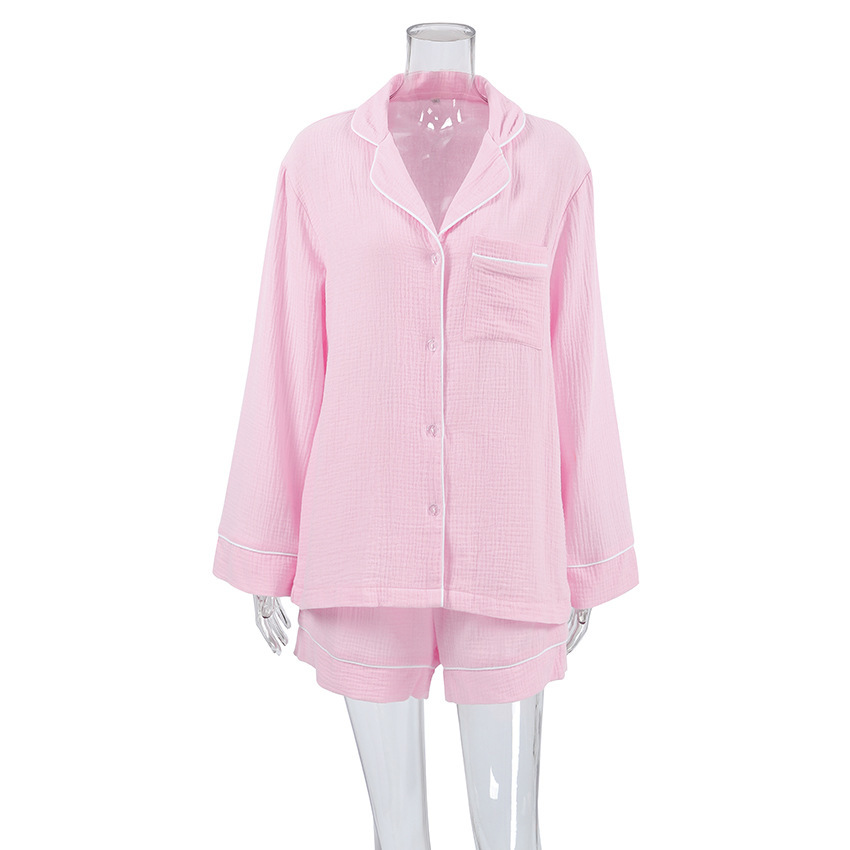 Pink pajama set on clear mannequin.
